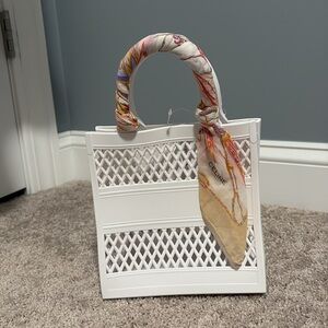 Celine scarf on a white vinyl basket tote